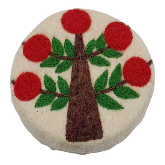 Round felted product with a tree design featuring red apples and green leaves on a white background