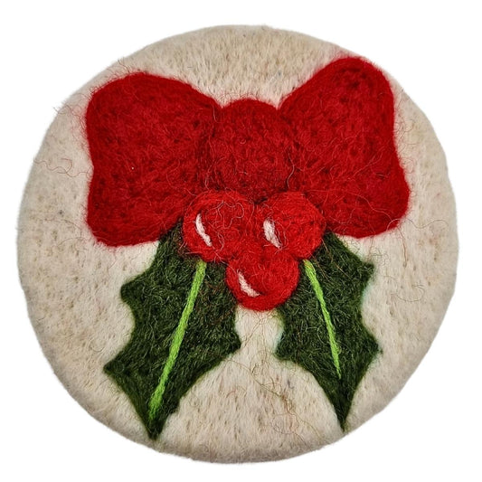 Round felted product with red flowers and green leaves on a white background