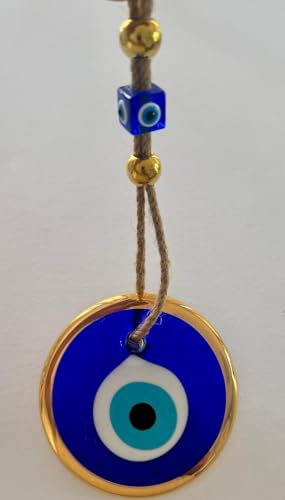 Blue evil eye charm with gold border on a white background